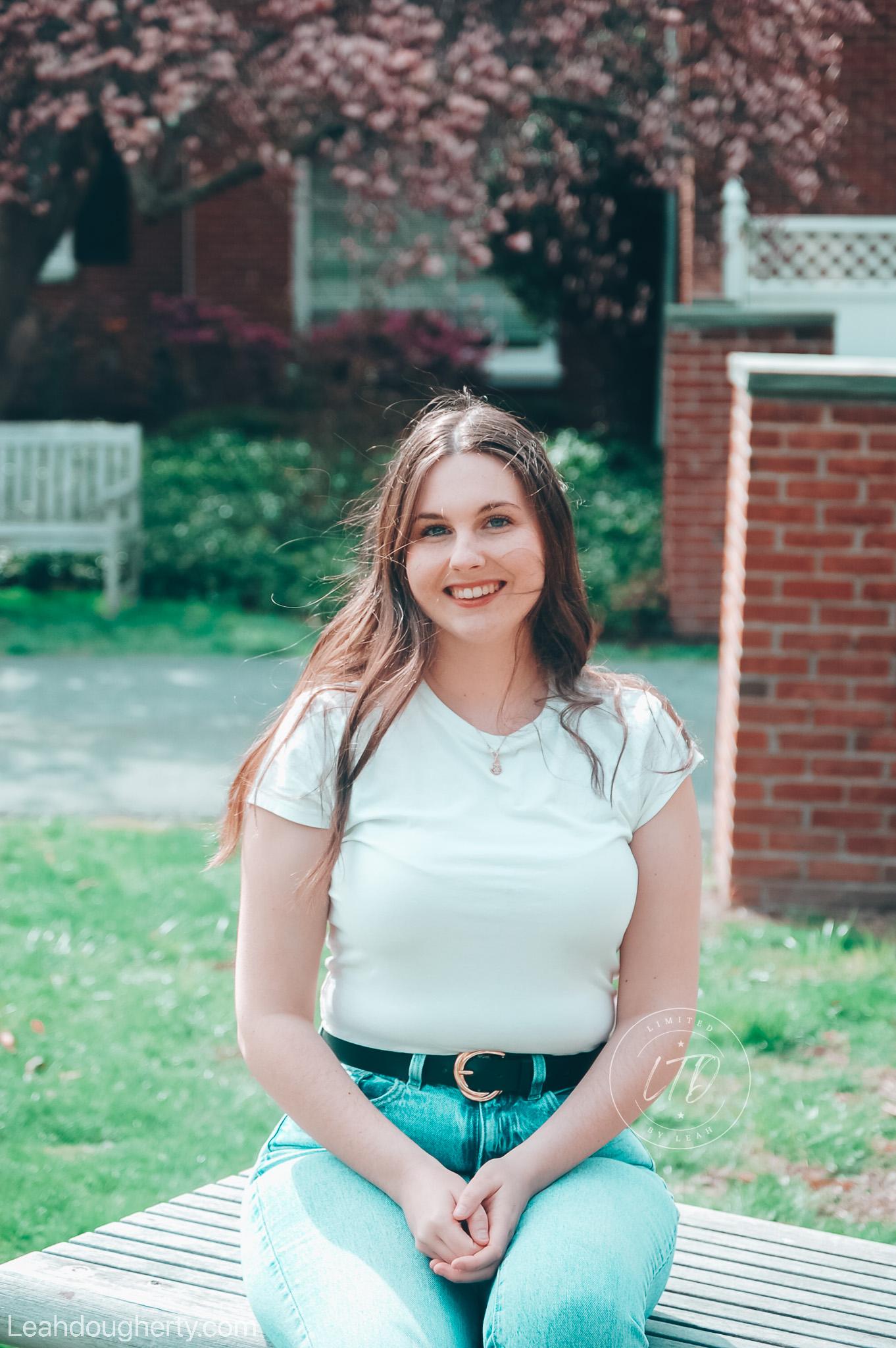 Leah sitting for a portrait in a garden